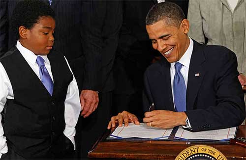 President Obama signs the Healthcare bill